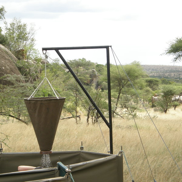 Open-air bucket showers are set up for your group.