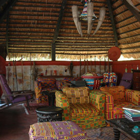 The decor is an eclectic mix of fabrics and unique artworks.