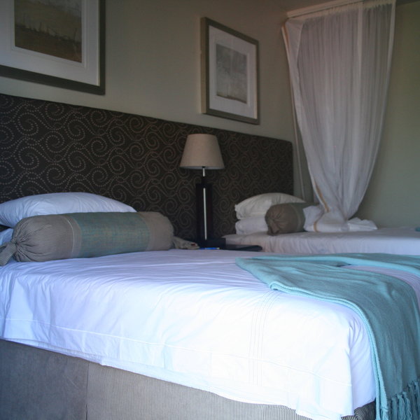 ...which features a comfortable twin and double beds with a decorative mosquito net,...