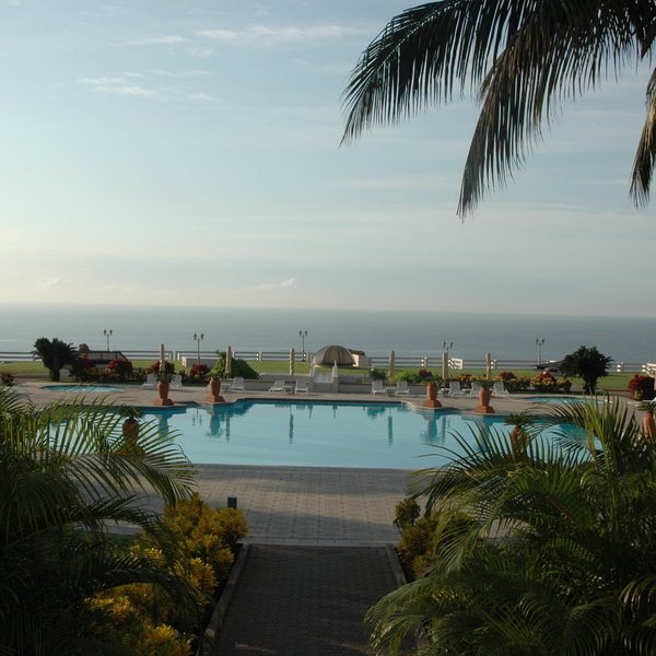 There is a large swimming pool available overlooking the ocean.