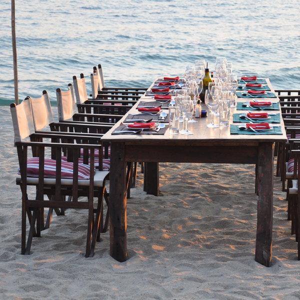 ..a long dining table, which will often be set out on the beach...