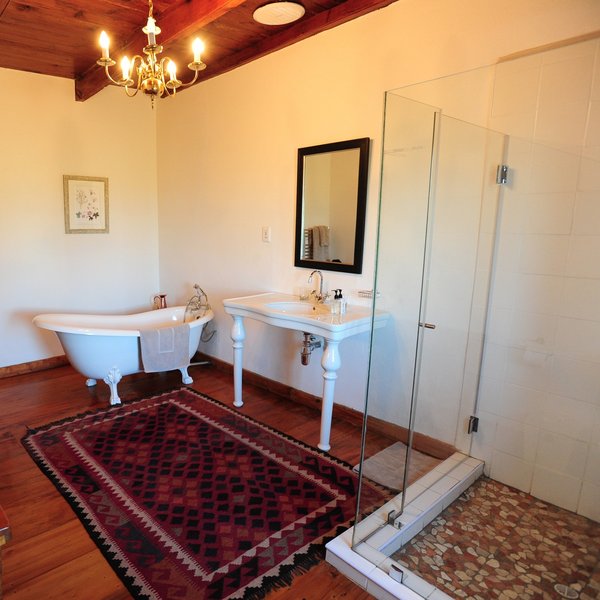 The bathroom here features a bath, wash basin,...