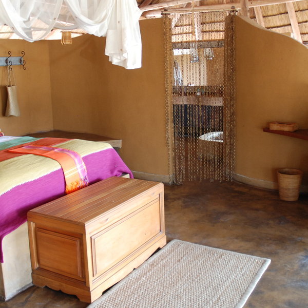 The ensuite bathroom is accessed through a bead curtain...
