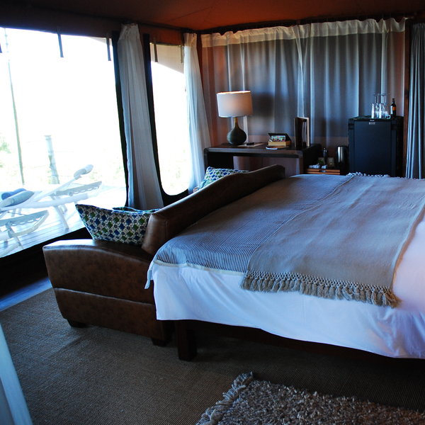 Each has a double or twin beds, and a sofa looking through gauze windows into the bush.