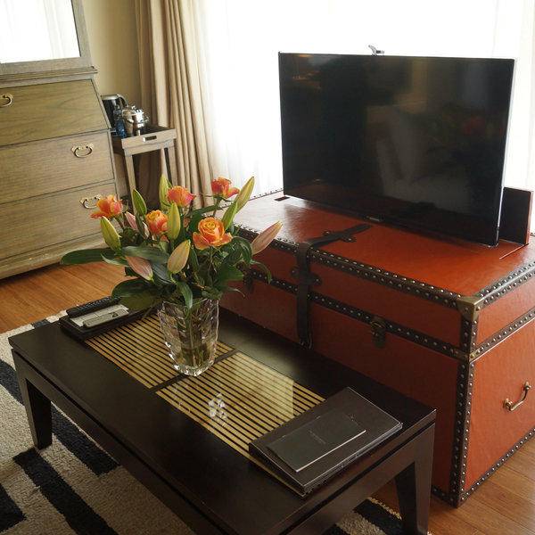 …big, flat-screen TVs that retract into a chest at the foot of the bed…