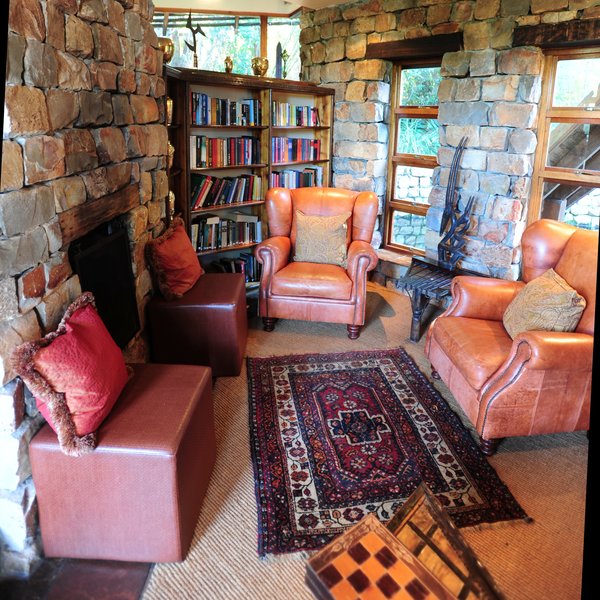 ... with a fireplace, ethnic carpets and sofas with colourful cushions.