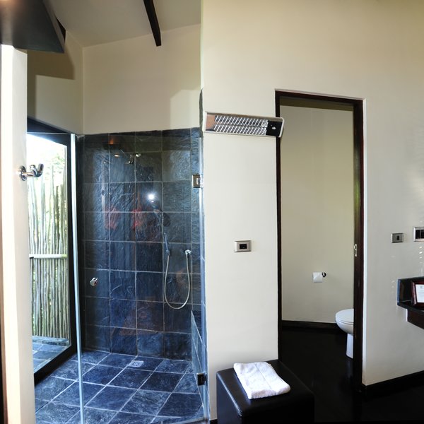 The bathroom comprises an indoor and outdoor shower ...