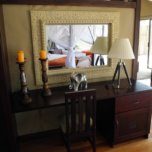 The rooms are well appointed, with a dressing / writing table to the side of the bedroom...