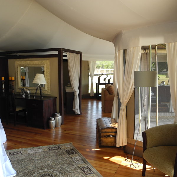 The tents have large windows and plenty of dark wood furnishings