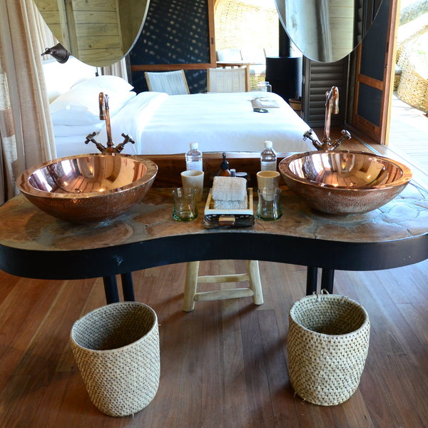 ...en-suite bathroom with copper his-and-hers sinks...