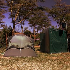 The simple dome tents sleep two adults and have private bathrooms just behind.