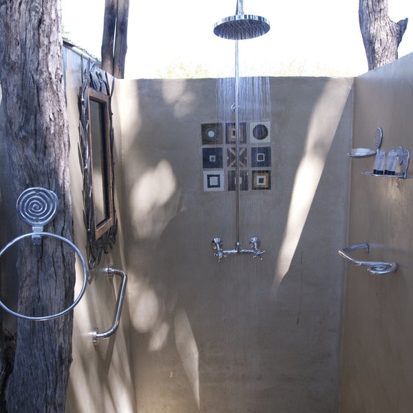 At the side of each tent is an additional, outdoor, shower...