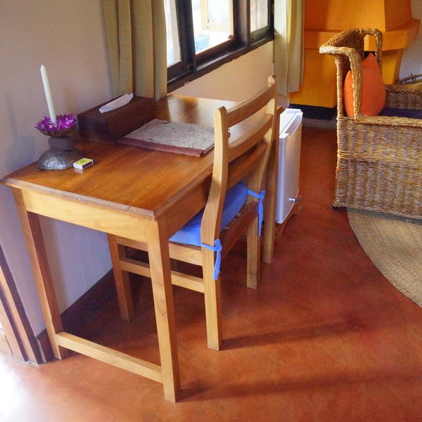 … a wooden desk with a chair, …