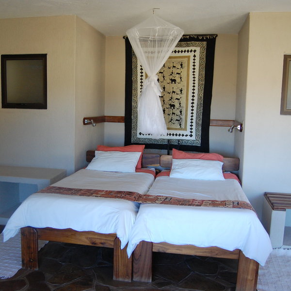 Each room has a double bed with a mosquito net…