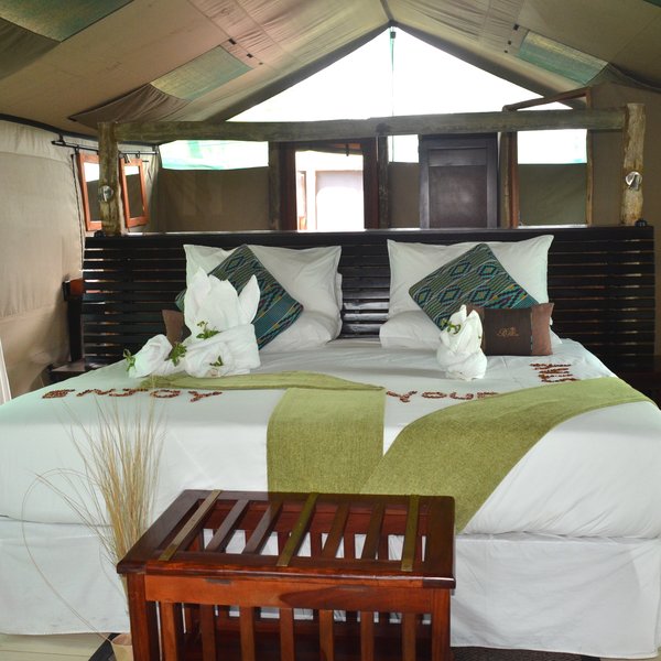 The rooms feel light and airy; each has double or twin beds...