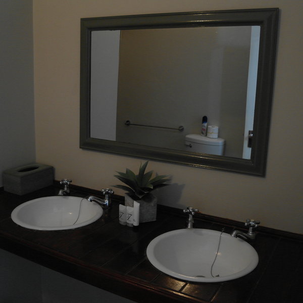 The en-suite bathroom has double basins,...