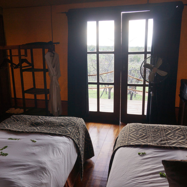The bed(s) face a large french-windows, that lead out onto the balcony.