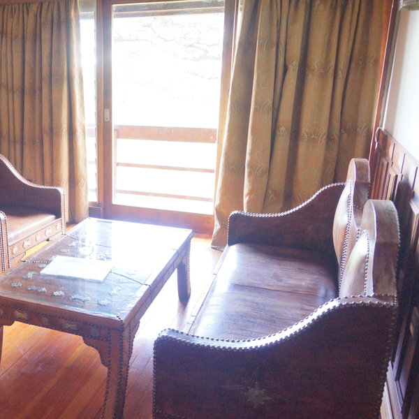 There is also a lounge area with comfortable brown leather sofas and low coffee tables.
