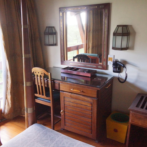 …a dressing table with a large mirror and a hair dryer.