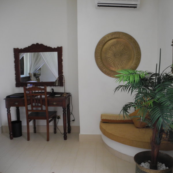 ...a small writing desk with a mirror in the corner...