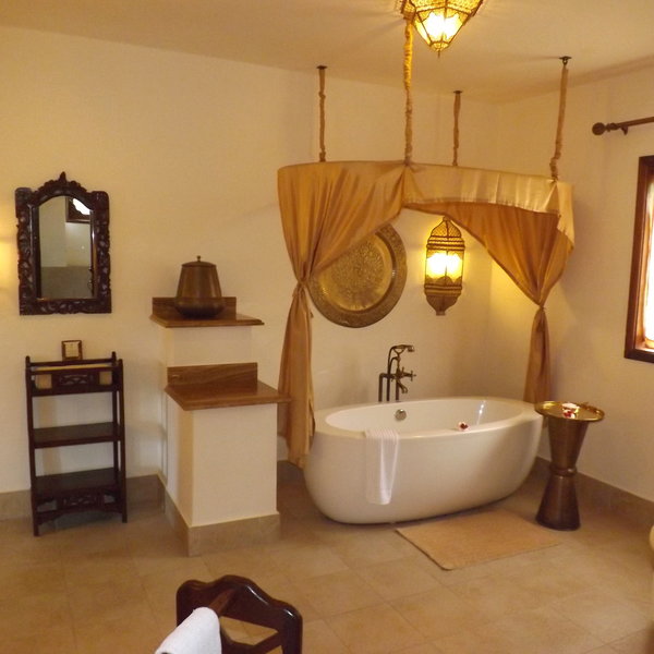 ...and a spacious bathroom, also decorated in gold and white.