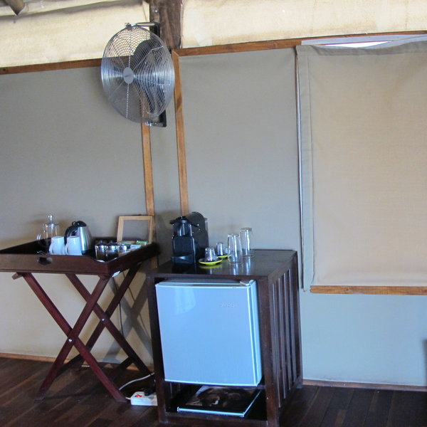 ...to one side are a minibar, tea coffee and fan.