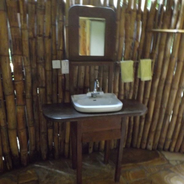 The bathroom is also simple and clean, with a basin, mirror...