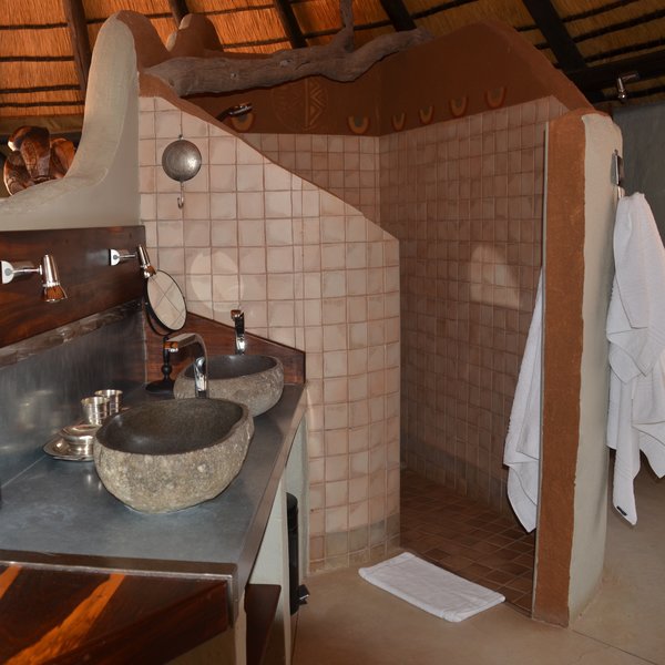 Behind a curved wall is the en-suite bathroom with a walk in shower