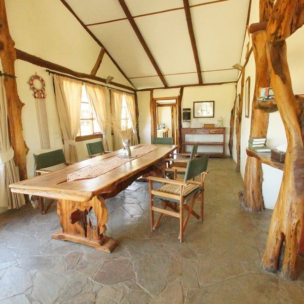 Beyond is the dining room, and a table big enough to seat 8 or 10 guests.