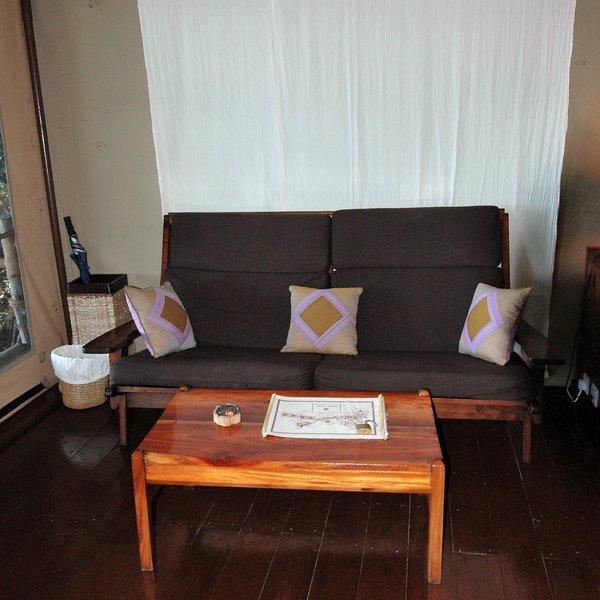 Each tent has comfortable sofa and low table, and cream fabric draped from the ceiling...