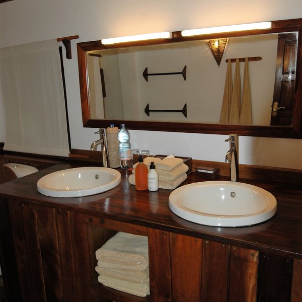 At the back of the tent is a small en-suite bathroom, with twin sinks...