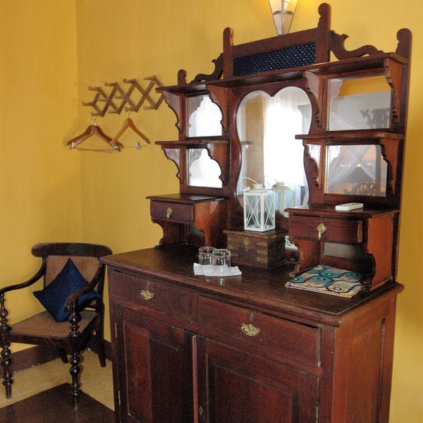 ..using antique furniture and traditional fabrics