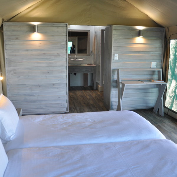 ...double or twin beds amongst the stylish washed planks that form the structure of the room.