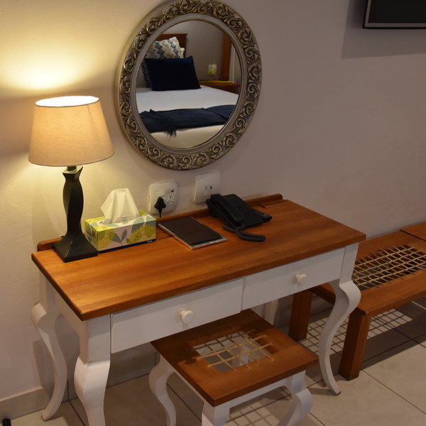 ...with amenities such as a writing desk, phone, hairdryer, DSTV, A/C and safe.