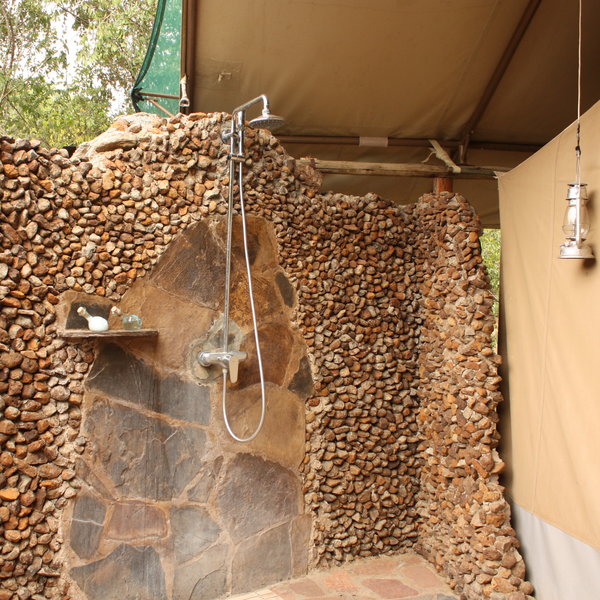 Behind the bathroom, and partly open to the sky, there's a shower area…