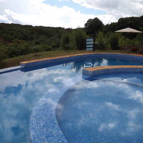 ... and an oval shaped pool surrounded by sun loungers.