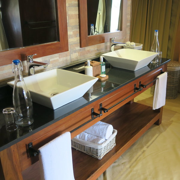 The en-suite bathroom is equally stylish, with twin sinks...