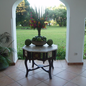 Beautiful flower arrangements are dotted around, sitting on hand made furniture.