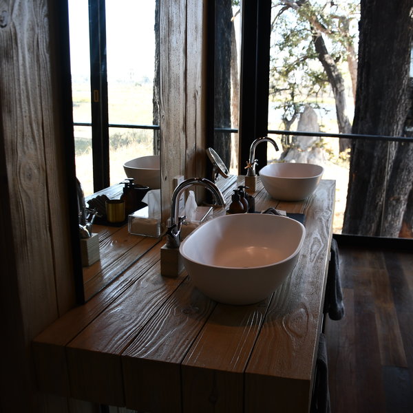 The bathroom is at the far end of the suite, with his and hers sinks...