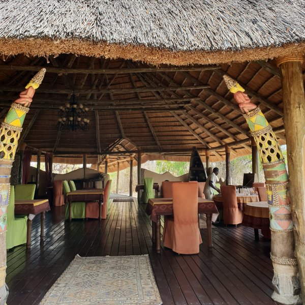 The dining area is to the side and entered between two tusk-like totem poles.