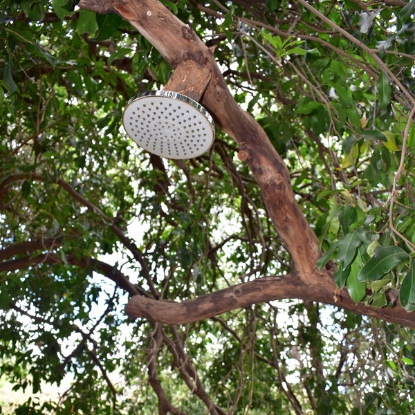... with an outside shower underneath the trees.