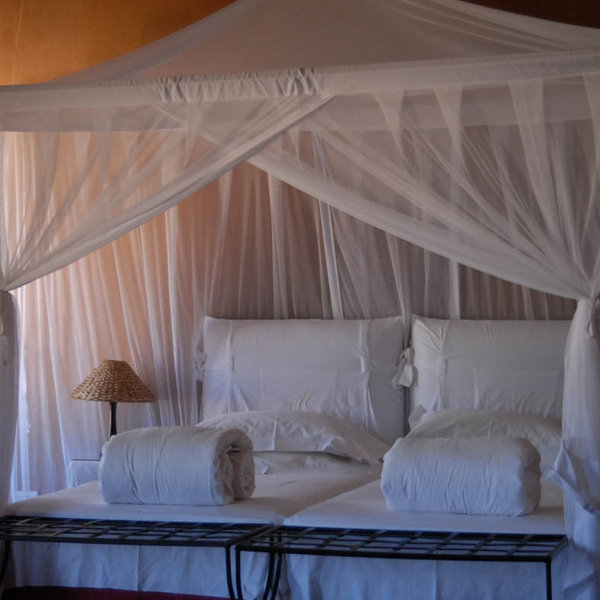 The rooms continue the Morroccan theme with large beds and sweeping mosquito nets...