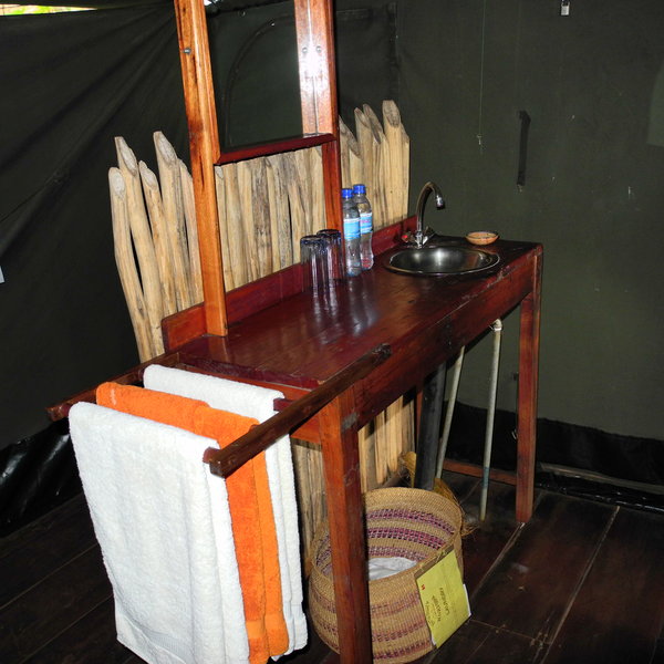 Low bamboo divides separate the flush toilet from the shower.